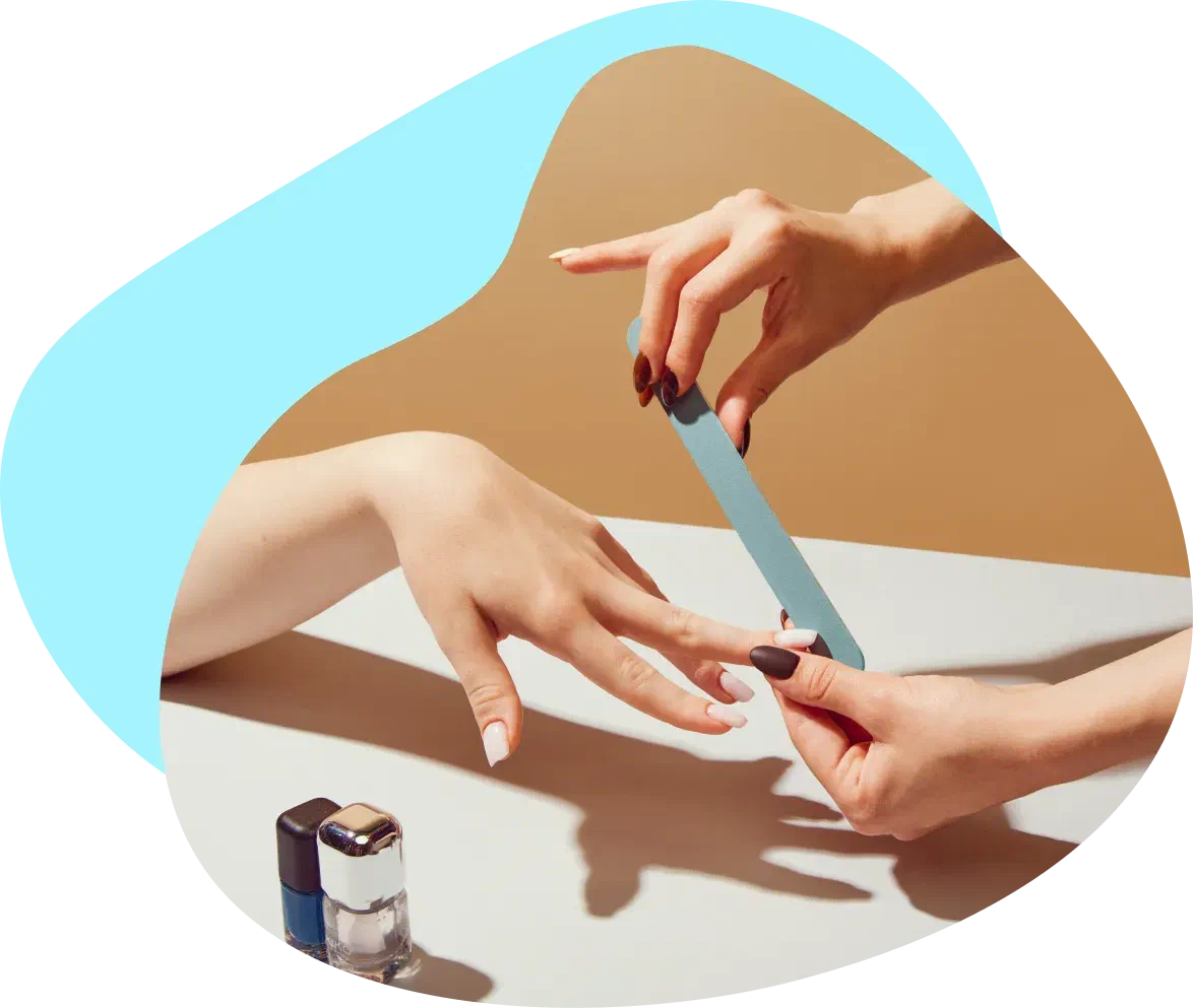 A nail technician working with a client